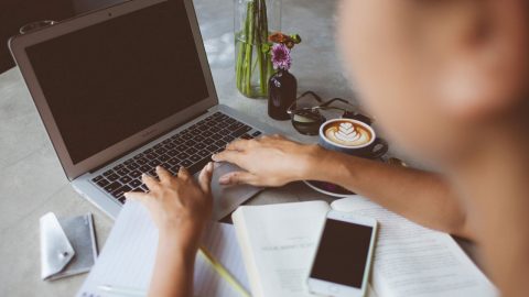 person typing on laptop