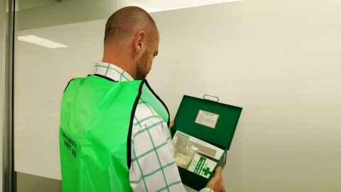 A University first aider wearing a green high-visibility vest.