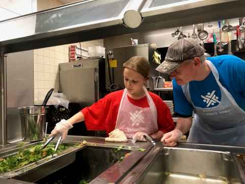 Helping prepare fresh meals at Part of the Solution, New York