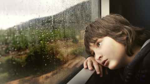 Boy looking out a window