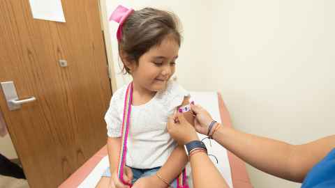 A baby looks on from mother's lap as a doctor prepares to give a vaccination. Don’t delay vaccines, get baby’s immunity going as soon as possible is the message to parents from vaccinologist Dr Helen Petousis-Harris. Photo: iStock