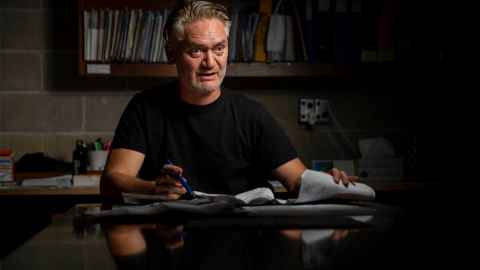Anthony Hoete, Professor of Architecture, sitting at his drawing board.