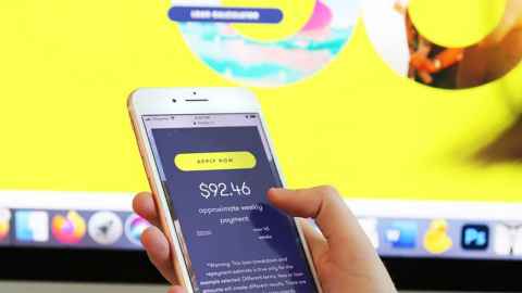 The image shows a mobile phone being used with a money-lending app on the screen: The $2.8m in unreasonable credit and default fees Moola charged current and former borrowers from February 2016 to July 2017 must now be credited or refunded. Photo: Lynn Grieveson, Newsroom