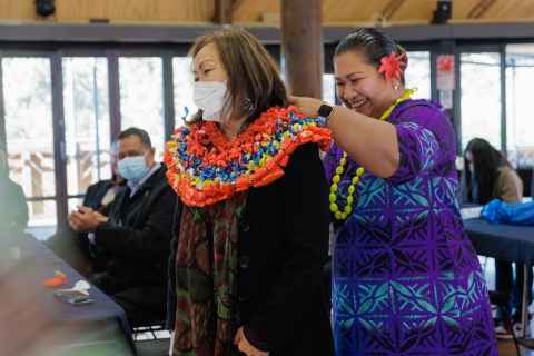 Aunty Judy being adorned with lei from members of the ECE Community.