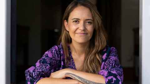 Dr Sarah-Jane Paine (Tūhoe) smiling with arms folded.