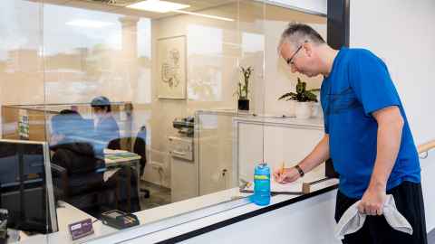 A Health and Rehabilitation Clinic client signs in before his exercise session.