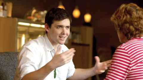 A speech language therapist works with a client