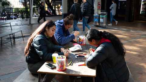 Students writing tips for wellbeing wall
