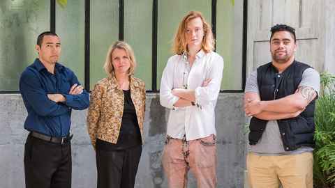 Four people standing in solidarity against family violence