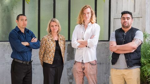 Four people standing in solidarity against family violence