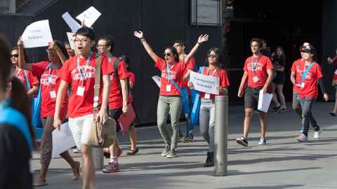UniGuide holding a sign up sheet.