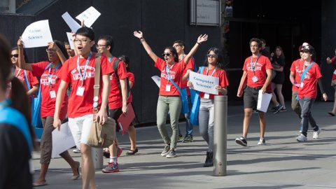 UniGuide holding a sign up sheet.