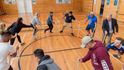 Sports students playing a stick game.