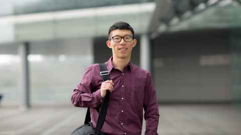 smiling international student outside business school