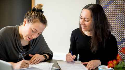 Two women writing