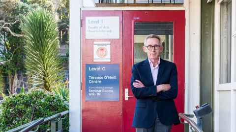 Dr Terry O'Neill at the door to the centre renamed after him in 2021.