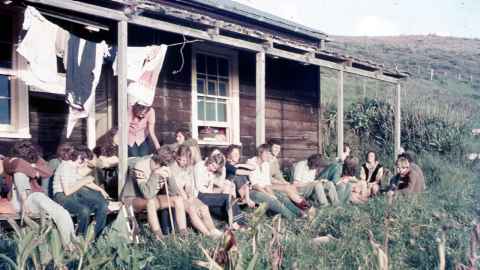 Auckland University Field Club students in front of a hut.