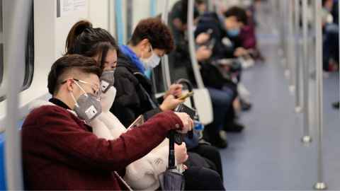 The new coronavirus is spreading to many cities in China. People wearing surgical masks are pictured sitting on a subway train in Shanghai. Photo: iStock
