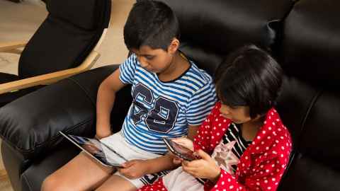 Two children on devices