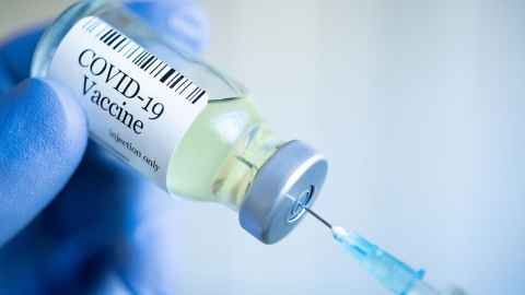 The image show a close-up of a gloved hand holding a vial of Covid-19 vaccin and inserting a syringe: Claims that suggest an alarming rate of “deaths and serious injury” caused by the vaccines are deeply misguided, writes Helen Petousis-Harris. Photo: iStock