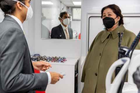 Mobile optometrist Veeran Morar shows the Governor-General, Dame Cindy Kiro around the Vision Bus Aotearoa