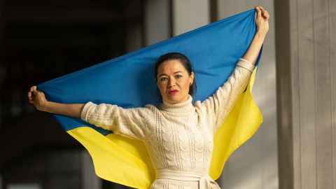 Natalia Booth holding up a Ukrainian flag. 