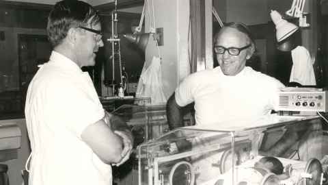 Black and white photo of Ross Howie, left, and Mont Liggins in a hospital.