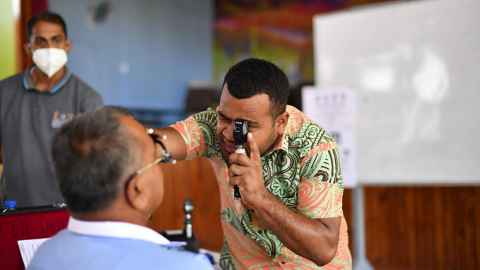 Pacific eye doctor examines patient.