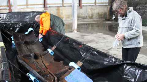 Dilys working on the 700-year-old Anaweka waka at a satellite lab in Golden Bay in 2013. The waka featured a distinctive turtle design.