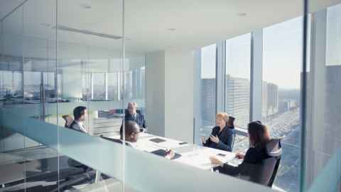 Image of business meeting in high rise modern office