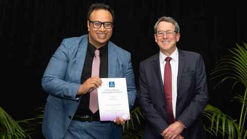 Dr Patrick Thomsen, a queer Pacific scholar at Waipapa Taumata Rau, alongside Professor Jim Metson at the 2022 Research Excellence Awards