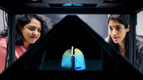 Dr Joyce John and Atefeh Rahimi display their lung research on a hologram projector.