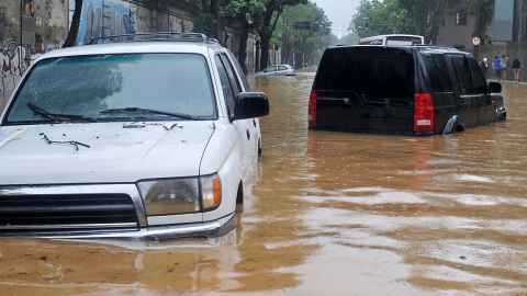 Severe flooding submerging vehicles parked on the road