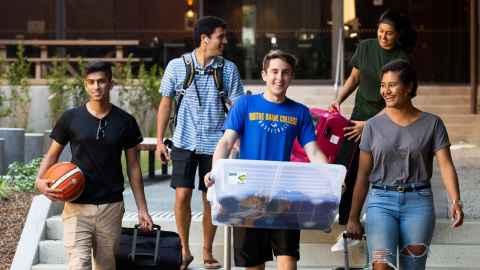 students with luggage moving into residence