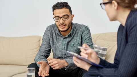 A clinical psychologist works with a client