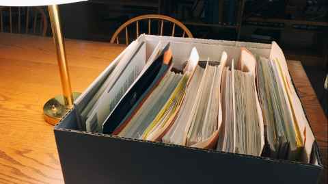 A box of documents on a desk.