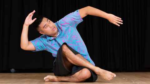 Person stretching their arm in a dance pose